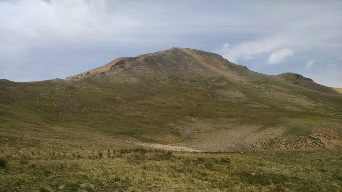 The true summit of Redcloud Peak appearing above the false summit