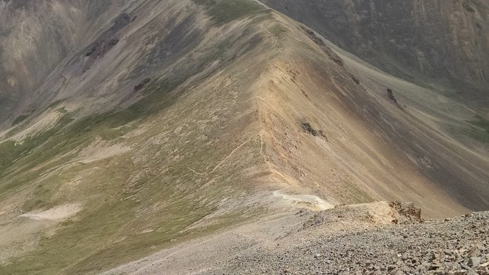 The multicolored saddle between Redcloud Peak and  Point 13,561' from near Redcloud's summit