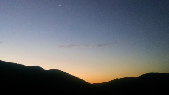 Looking east toward sunrise and a crescent moon from the King Lake Trail.